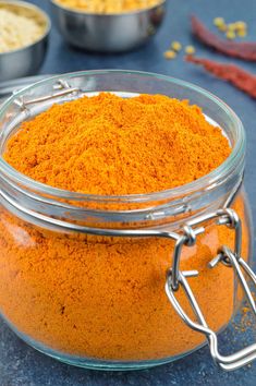 a glass jar filled with orange colored powder