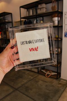 a person holding up a piece of paper with the words viva written on it