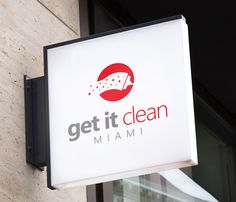 a sign that says get it clean hanging from the side of a building