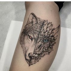 a woman's thigh with a wolf tattoo on it