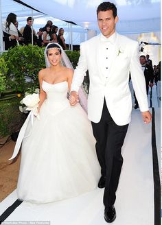 a bride and groom walking down the aisle