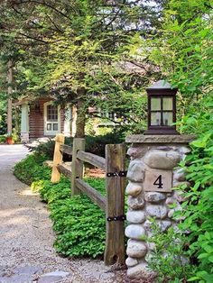 a stone fence with a lantern on top