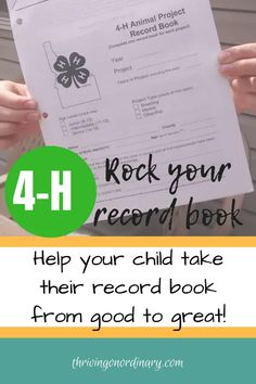 a person holding up a record book with the text 4 - h rock your record book