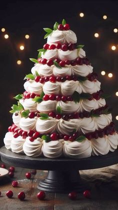 a christmas tree made out of meringue and cranberries on a cake plate