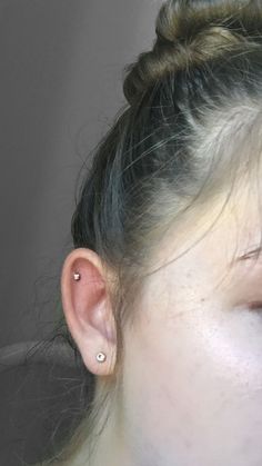 a close up of a person with ear piercings