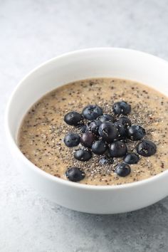 a bowl of oatmeal with blueberries and chia seeds in it