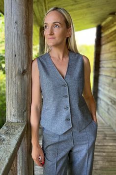 Timeless style twill wool fabric vest delivers official look with a touch of modern feeling. Handmade garment features inner lining, hidden front pockets. Clean cuts, minimalist style and lovely buttons become a perfect piece for slow fashion people. Lightweight wool-blend twill waistcoat is so easy to wear. Women's vest is designed in a regular fit.  Wool twill fabric is a lightweight, flowing fabric that looks great in all shapes. Breathable and comfortable properties make it a top choice for Fitted Gray Vest, Wool Vest With Pockets For Work, Wool Vest With Button Closure For Workwear, Classic Wool Vest For Office, Winter Workwear Vest With Welt Pockets, Classic Wool Vest With Button Closure, Sleeveless Gray Outerwear For Work, Classic Gray Vest For Work, Tailored Wool Vest