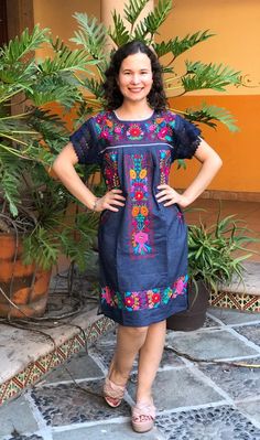 Beautiful denim dress embroidered by hand by artisans from the state of Oaxaca, Mx. comfortable and fresh, with lace details and drawstring to adjust at the waist. The embroidery is unique to each dress so it may vary. Mexican textile art has centuries of history and creativity throughout the country. Mexico is recognized as one of the leading countries with a beautiful artistic production in the textile world, miraculous hands of talented artisans from different states of the country create stu Fitted Bohemian Denim Dress For Summer, Blue Fitted Folk Dress, Fitted Blue Fiesta Dresses, Blue Fitted Dress For Fiesta, Fitted Blue Dress For Fiesta, Folk Style Cotton Floral Print Dress, Folk Style Cotton Dress With Floral Print, Bohemian Denim Dress With Floral Embroidery For Spring, Folk Style Fitted Floral Print Dress