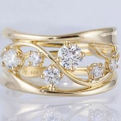 a gold ring with three diamonds on it