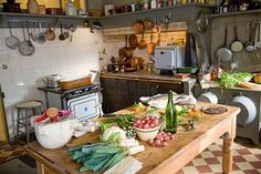 a kitchen filled with lots of cooking utensils on top of a wooden table