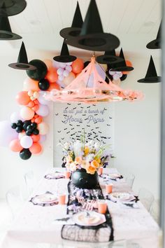 a party table with balloons and decorations