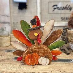 a wooden turkey sitting on top of a table