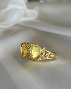 This Heart Locket Ring is crafted from gold plated silver for a luxurious feel and timeless look. Its elegant design is perfect for the special occasions that call for you to make a powerful, romantic statement. Wear it to express love, adoration, or devotion. Gold Plated Engraved Promise Ring With Polished Finish, Heirloom 14k Gold Couple Promise Rings, Gold Plated Heart Ring For Gift, Valentine's Day Heirloom Ring Jewelry, Heirloom Style Valentine's Day Jewelry Ring, Valentine's Day Heirloom Ring, Gold Heart Open Ring For Proposal, Gold Jewelry For Valentine's Day Proposal, Gold Sterling Silver Promise Couple Rings