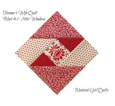 a red and white quilted square with flowers on it