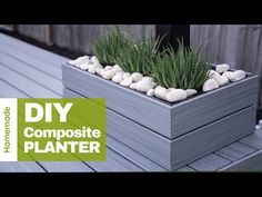 a planter with rocks and grass in it