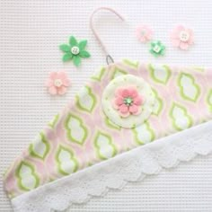 a close up of a pink and green headband with flowers on it