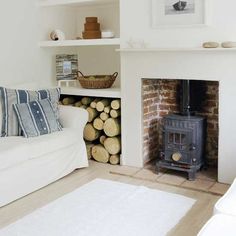 a living room filled with furniture and a fire place next to a white couches