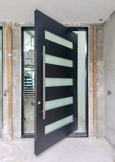 an open black door in the middle of a room