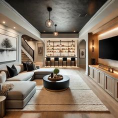 a living room filled with lots of furniture and a flat screen tv mounted to the wall