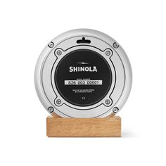 the shinola award is shown on a wooden base with an inscription that reads,