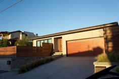 a house with a large driveway and two garages on the other side of it