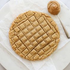 a peanut butter cookie on a plate with a spoon