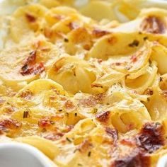 a casserole dish with pasta and cheese in a white dish on a table