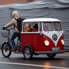 two people riding on the back of a red and white vw bus