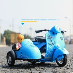 a blue toy motorcycle with a person riding on the back and sidecar in front