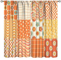 an orange and white curtain with different patterns on the outside, including flowery squares