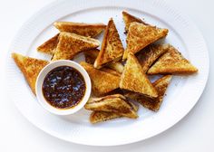 toasted pieces of bread on a plate with dipping sauce