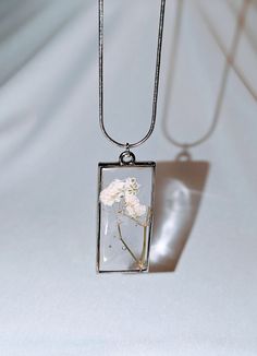 a necklace with a flower inside of it