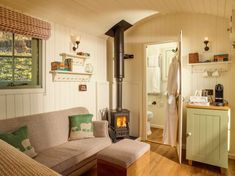 a living room filled with furniture and a wood stove