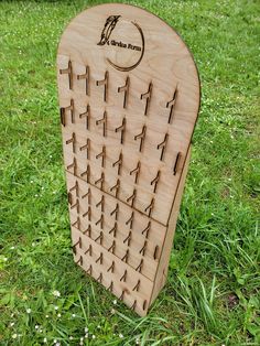 a wooden board with arrows on it in the grass