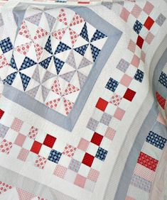 a quilted blanket with red, white and blue designs on it's edges