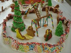 a decorated cake with lots of decorations and trees on it's sides, including a merry - go - round