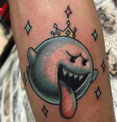 a cartoon character with a crown on top of it's head and tongue sticking out