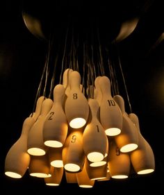 a bunch of lights that are hanging from the ceiling in a dark room with numbers on them