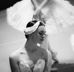 black and white photograph of two women in dresses with one woman wearing a head piece