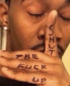 a man holding his hands to his face with words written on it