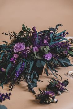 purple flowers and greenery on a table