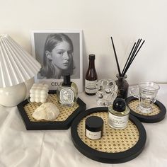 three trays with bottles and candles on them