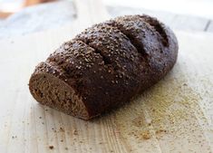 a loaf of bread sitting on top of a wooden cutting board