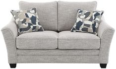 a gray couch with two pillows on it