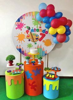 a birthday party with balloons, cake and decorations