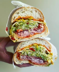 two halves of a sandwich with meat and vegetables