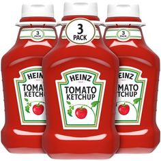 three bottles of heinz tomato ketchup on a white background