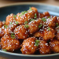 sesame chicken with sesame seeds in a blue bowl