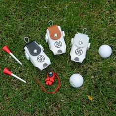 several golf accessories laid out on the grass