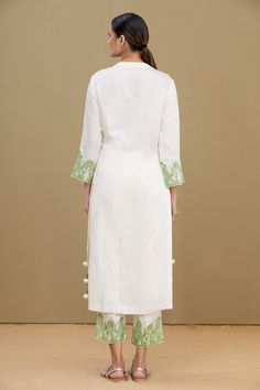 White kurta with pistachio green thread embroidery at the placket and sleeves. Comes with straight fit pant.
Component: 2
Embroidered
Neckline: Mandarin Collar
Sleeve Length: Full
Fabric: Linen Satin Blend
Color: White
Front button placket
Pom-pom detailing at the side seams
Embroidered straight fit pant - Aza Fashions Collar Kurta, Green Thread, White Kurta, Straight Fit Pants, Pistachio Green, Embroidered Neckline, Thread Embroidery, Fashion App, Pant Set